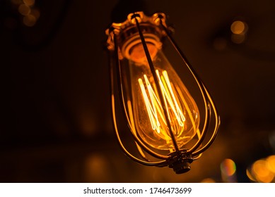 Decorative Lightbulb Close-up, Shallow Depth Of Field. Orange Tinting