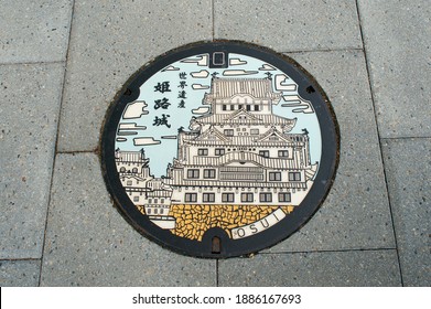 A decorative manhole cover depicting Himeji Castle in Himeji, Hyogo, Japan - text reads 