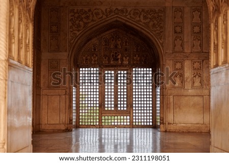 Decorative mesh window in Agra Red Fort, beautiful ancient windows with beautiful wall decorations, ancient window with old indian handmade ornament decoration in Agra Red Fort landmark building