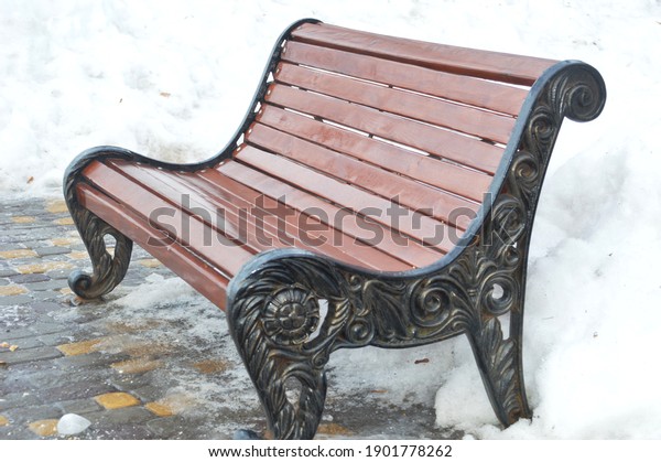 Decorative metal benches in a leisure park in\
a metropolis