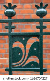 Decorative Metal Fencing With Red Bricks In The Background