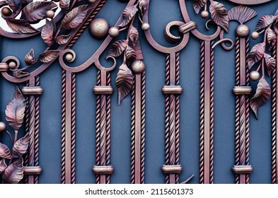 Decorative metal gates of blue and yellow colors with wrought iron elements