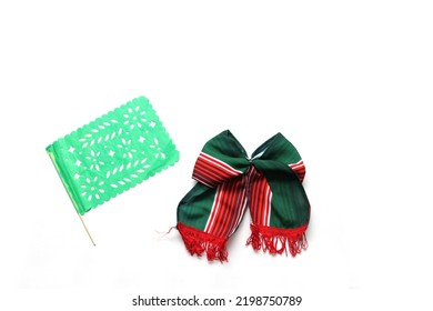 Decorative objects of Mexican party: pennants, green, white and red tricolor tie to celebrate Independence Day, Revolution and Day of the Dead in Mexico