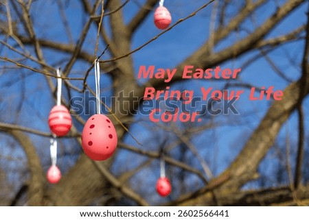 Decorative pink Easter eggs hang from tree branches against blue sky background with fun holiday message.