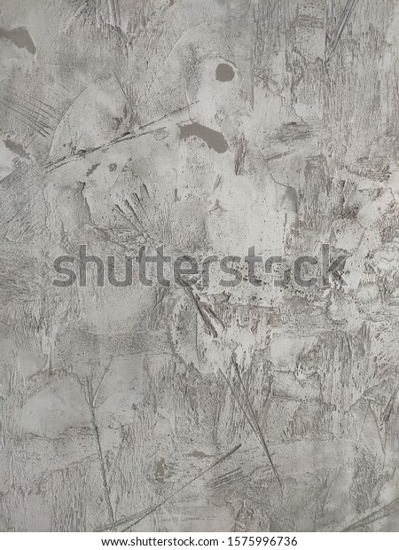 Decorative plaster\
of gray color, concrete\
wall