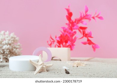 Decorative plaster podiums, coral, seaweed and starfish in sand on pink background - Shutterstock ID 2300178719