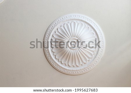 Decorative plaster rosette on the ceiling to complement the interior.