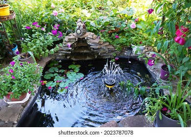Decorative pond with fountain in the garden