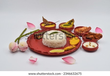 DECORATIVE PUJA BHOG THALI ISOLATED ON WHITE BACKGROUND. FRONT ANGLE VIEW WITH SELECTIVE FOCUS WITH GGRAINY TONE.