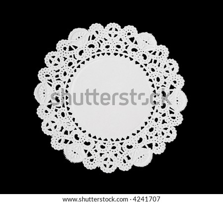 A decorative round doily isolated over black