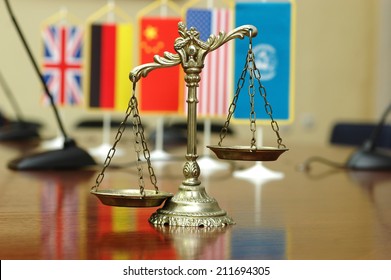 Decorative Scales Of Justice With Blurred National Flag Of Different Countries, Concept Of International Law And Order, Focus On The Scales
