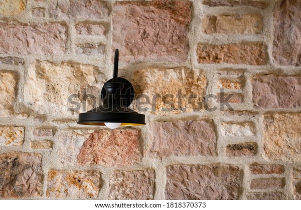decorative sconce on the stone\
wall