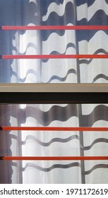 Decorative Shadows On Lace Curtain Cast By Burglar Bars And Window Frame