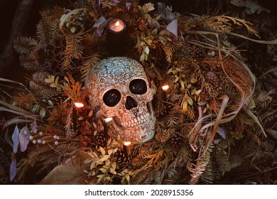 Decorative Skull, Candles And Dry Autumn Leaves On Dark Natural Background. Symbol Of Halloween Holiday, Samhain Sabbat. Magic Esoteric Ritual. Mysticism, Wicca, Occultism, Witchcraft Concept