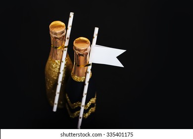 Decorative Sparkly Mini Champagne Bottle On Black Background, Celebration Theme.