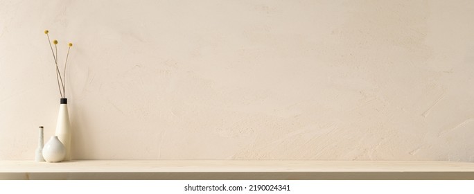 Decorative vase with branches at wooden table near bright wall. - Shutterstock ID 2190024341