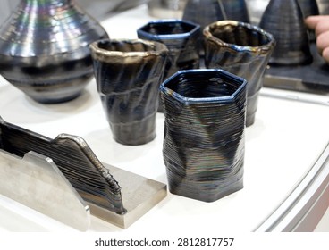 Decorative vase created using 3D metal printing. Metal model printed on 3D printer. Additive manufacturing from melted metal thread. Additive manufacturing. Object printed on 3D printer from metal