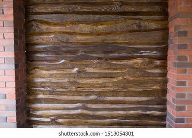 Decorative Wall Of Pine Boards Painted With Varnish. Wood Texture. Brick Column.