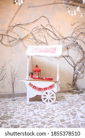 Decorative White Wooden Cart At Garden And Candy Bar  Winter. Street Food Cart. Candy Retro Cart With Desserts And Delicious Sweets. Christmas Fair Concept. Christmas And New Year Celebration