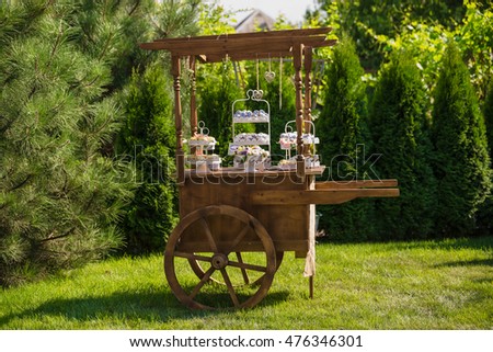 Decorative wooden cart in the garden and candy bar