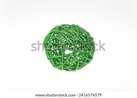 Decorative woven wicker or rattan green ball isolated on white.