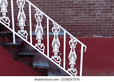 decorative wrought iron antique handrail with weathered red brick wall background - Powered by Shutterstock