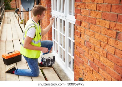 Decorator On Scaffolding Painting Exterior House Windows