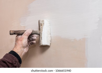 Decorator Prime A Putty Wall Before Applying A Decorative Layer Of Plaster, Repairs Work In The House, Second Stage, Workflow