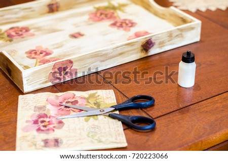 Decoupage box with scisor, paper and glue