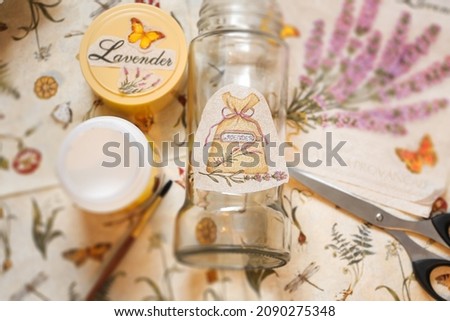Decoupage process with a glass jar. Glue, brush, scissors and paper napkins. Top view. Creativity, DIY background