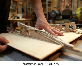 Decoupling and fixing the Top. Hand made classical guitar. Guitar manufacturing. - Shutterstock ID 1103137199
