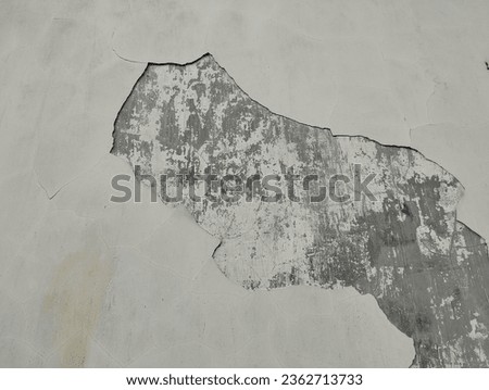 Decrepit cement wall with peeling paint, perfect for background designs