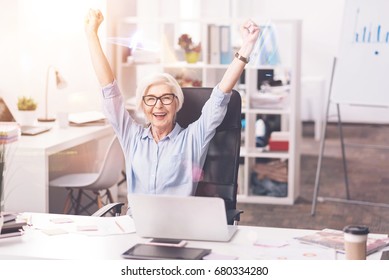 Dedicated hardworking woman cheering at her workplace