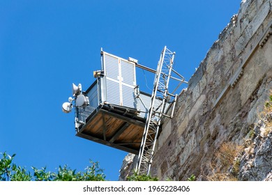 A dedicated lift takes visitors with disabilities to the top of Acropolis of Athens to visit historic ancient temples and see the city from above. Inclusive city infrastructure, Athens, Greece.