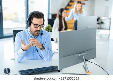 Dedicated male customer service representative communicating with customer trying to provide appropriate solutions for client issues at call center.