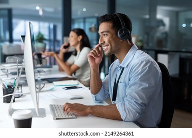 Dedicated service creates dedicated customers. Shot of a young man using a headset and computer in a modern office. - Shutterstock ID 2149264361