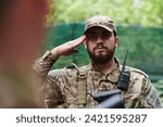 A dedicated soldier salutes his elite unit, showcasing camaraderie and readiness for the most perilous military operations