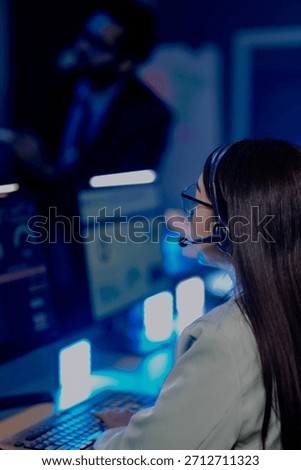 Dedicated support agent headset active listens intently customer issue screen shows account data CRM system late night resolving problems providing excellent service customer first focus now help.