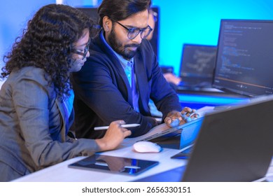 A dedicated IT team collaborates in a command center, working on a critical software deployment or incident response. Concept for system implementation, teamwork, and operations.