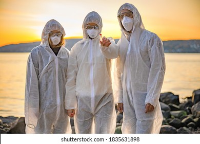 Dedicated Team Of Scientists Holding Water Sample At Beach