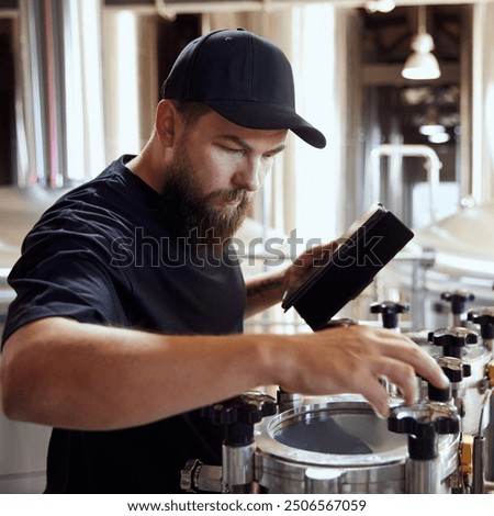 Dedicated technologist checking the brewing process, and equipment quality, maintaining perfect and well-equipped production. Concept of beer, brewery, manufacture, quality control