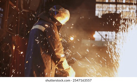 A dedicated worker is diligently creating sparks in a vibrant industrial environment. Stock Clip - Powered by Shutterstock