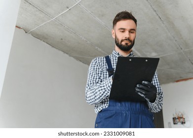 A dedicated worker doing calculations for material for apartment in construction process