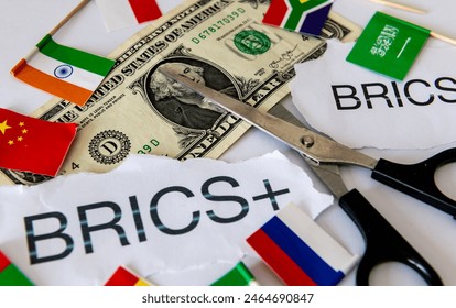 A dedollarisation concept with the words and country flags of the block of BRICS and BRICS+ countries, a pair of scissors and a US dollar bill. - Powered by Shutterstock