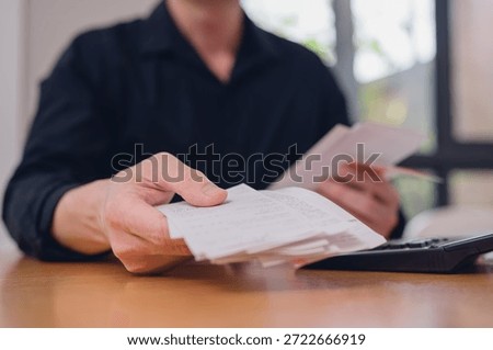 Deduction planning concept. hands using calculator to calculating balance prepare tax reduction income and holding bills, cost budget expenses pay money form personal Individual Income Tax Return