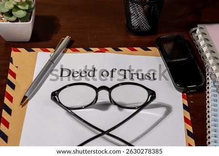 Deed of Trust Document on Envelope with Pen and Eyeglasses Represents Legal Security in Property Financing and Ownership