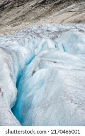 The Deep And Blue Crevasse Of The Jostedalsbreen Glacier In Norway Forms A Rough Landscape Of Endless Cracks And Holes. Adventurous, Outdoor Sports Scene. 