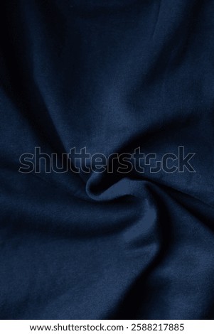 Deep blue fabric texture creates a calming, abstract pattern. The cloth's soft folds and subtle highlights add depth to the image.
