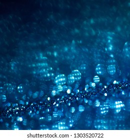 Deep blue glitter magic background. Defocused light and free focused place for your design. Abstract background - Shutterstock ID 1303520722