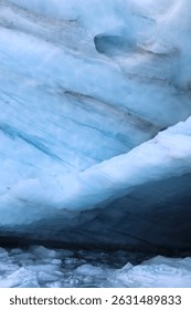 Deep blue ice cave inside Brewster Glacier, Mount Aspiring National Park, New Zealand. A dramatic symbol of climate change, glacial retreat, and natural beauty in the Southern Alps. Background image.